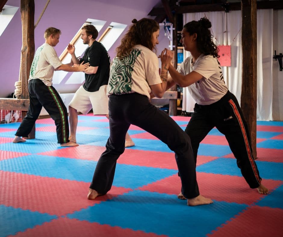 people practicing partner gi gong in the dojo